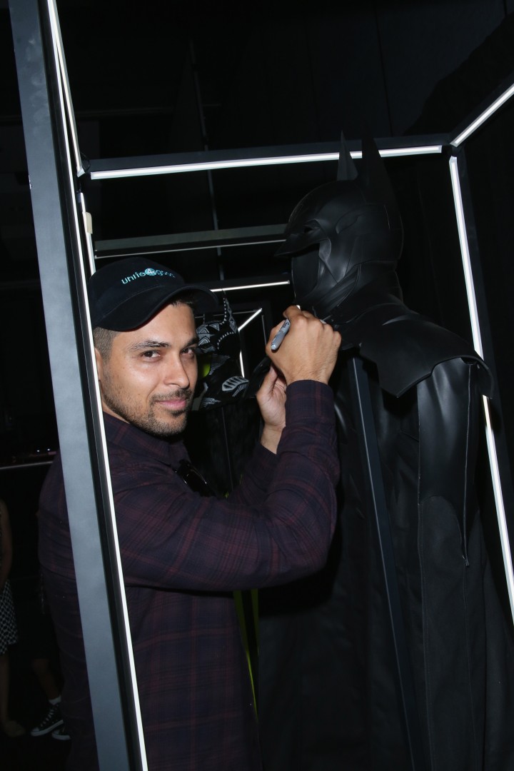 Actor Wilmer Valderrama autographs Batmans cape and cowl during Warner Bros. Interactive Entertainments Cape/Cowl/Create unveiling event during Comic-Con International 2014 at Hard Rock Hotel San Diego on July 24, 2014 in San Diego, California. (Photo by Mark Davis/Getty Images for Warner Brothers Interactive Entertainment)